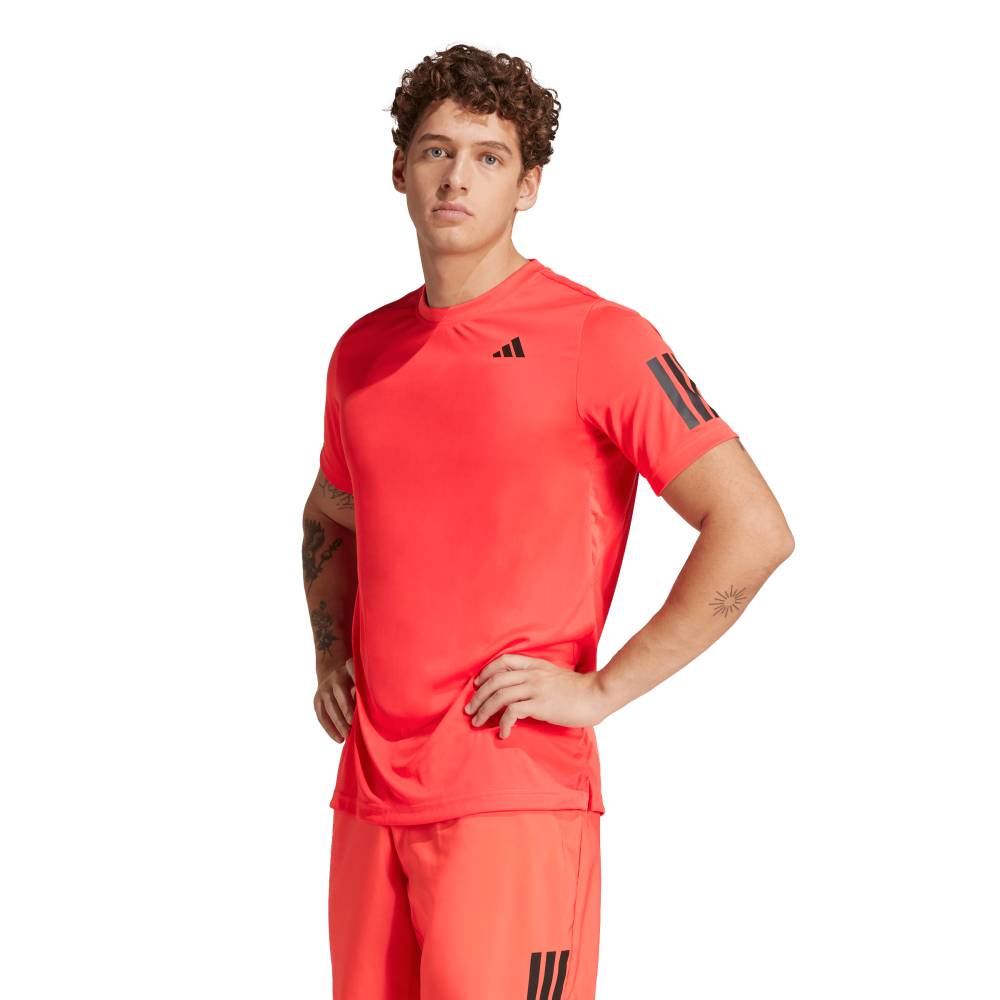 Person wearing a red Adidas sports outfit on a white background