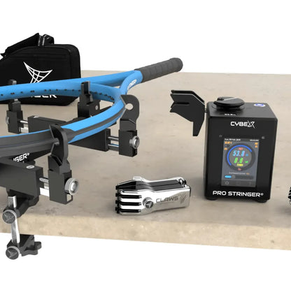 Tennis racquet stringing tools and equipment on a table, including a Cybex Pro Stringer and Clavis tool.