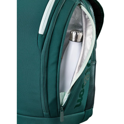 Green backpack with a white water bottle inside on a white background
