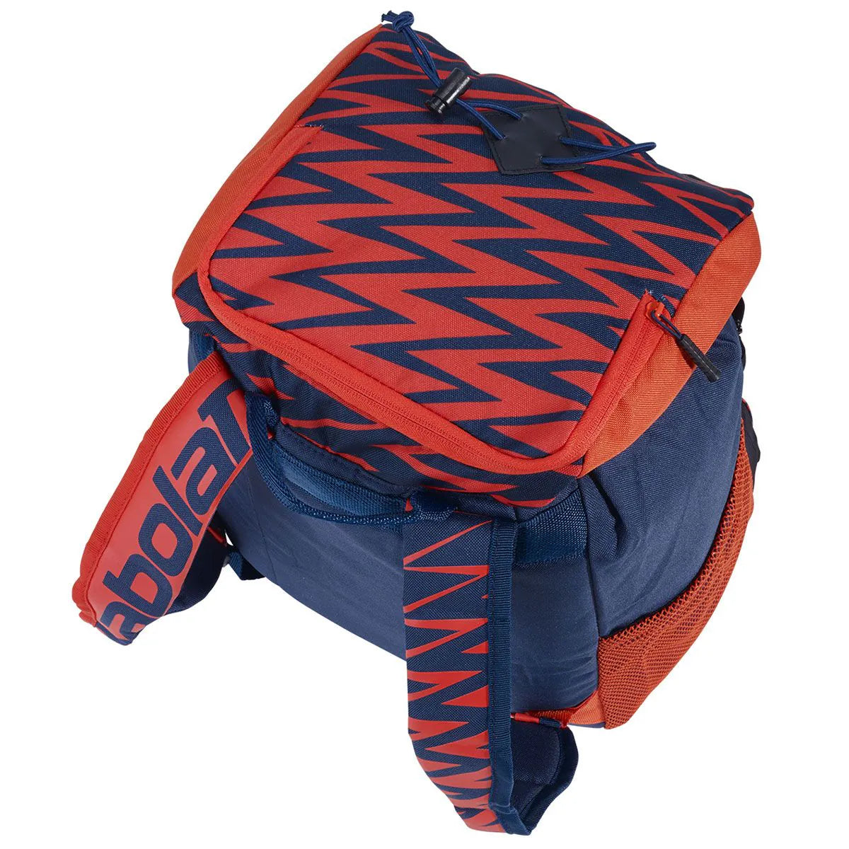 A Babolat tennis bag featuring a navy blue and red zigzag pattern on the top flap, with solid navy blue fabric on the lower body and a red-orange mesh side pocket, shown on a white background.